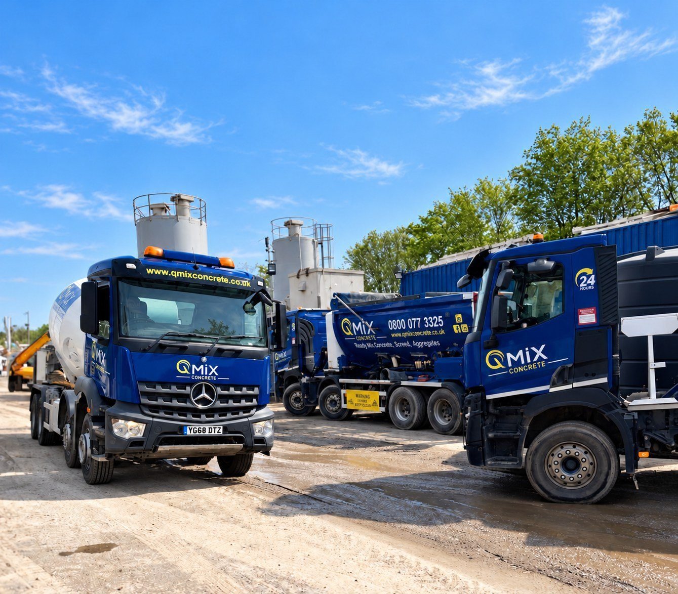 QMiX Concrete trucks at the yard under a bright blue summer sky